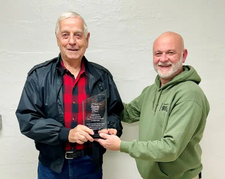 A longtime member of the DeKalb County 911 Emergency Communications District Board of Directors has been recognized for his 28 years of service.Billy Adcock, who officially retired on October 31, was presented a plaque Thursday night, December 7 by Director Brad Mullinax.
