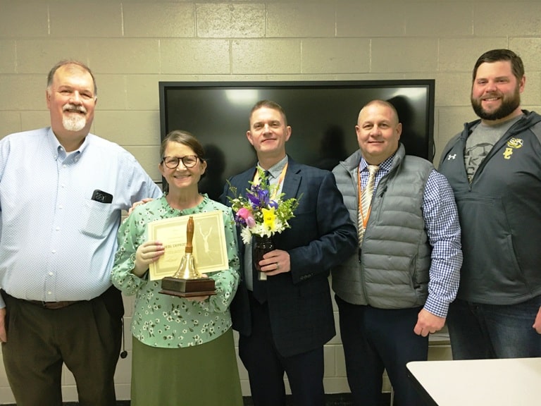 Debi DePriest, the school level Teacher of the Year at DCHS, was visited in her classroom Tuesday morning by Principal Bruce Curtis, Director of Schools Patrick Cripps, Supervisor of Instruction Randy Jennings, and Assistant DCHS Principal Thomas Cagle who presented her with a school bell award, a floral arrangement, and a certificate granting her a day off from school with pay.