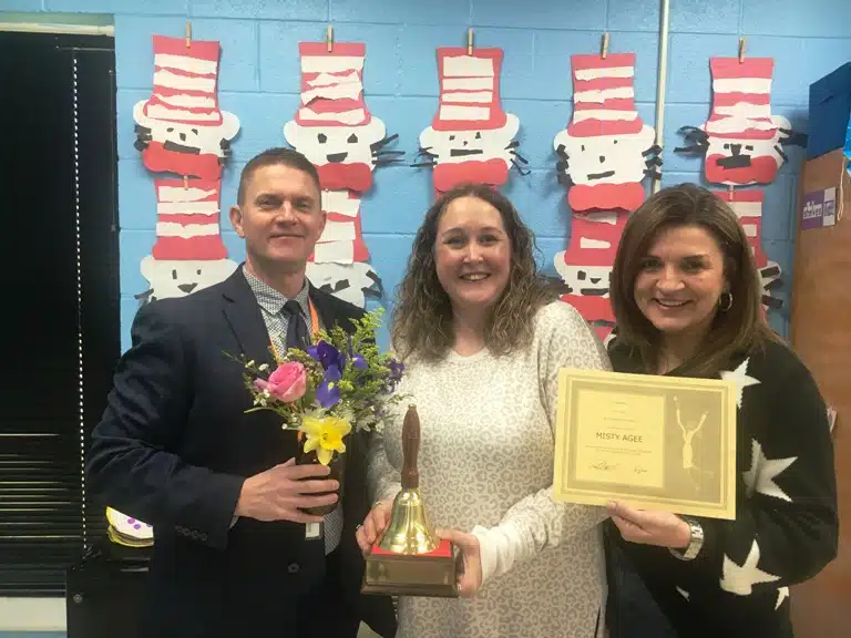 Misty Agee, the school level Teacher of the Year at Smithville Elementary School, was visited in her classroom Tuesday morning by Principal Anita Puckett and Director of Schools Patrick Cripps who presented her with a school bell award, a floral arrangement, and a certificate granting her a day off from school with pay.