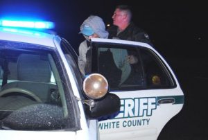 Man involved in White County law enforcement pursuit being placed into custody by White County Sheriff’s Department Officer at the intersection of South Mountain and Hayes Street in Smithville at 2:45 a.m. Saturday after the Dodge Neon he was in wrecked and he and a woman tried to get away on foot.