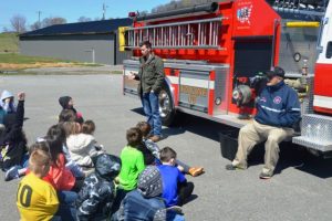 Matt Adcock and Jerry Johnson with the DeKalb County Fire Department tell students about working as a firefighter during DWS's Annual Career Day.