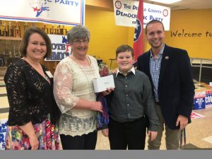 Circuit Court Clerk Katherine Pack, who is retiring from office after her term expires August 31, was presented a special gift during the DeKalb Democratic Party Mass Meeting Saturday. The presentation of a clock was made by Circuit Court Clerk candidate Nicole Wright, an employee of the office, and Party Chairman Jordan Wilkins. Pack's grandson Brayden Summers also gave her a bouquet of roses