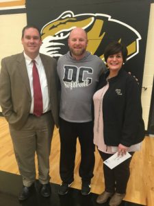 Casey Midgett (left) and Rhonda Caplinger of Liberty State Bank present donation to DCHS Tigerette Softball Coach Danny Fish