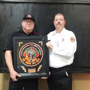 The 2017 "Git R Done Award" goes to two firefighters including Steve Repasy, Station Commander of the Johnsons Chapel Station (left) presented by Captain Jay Cantrell. Blake Cantrell (not pictured) will also receive the award.