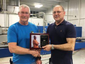 Tracy Foutch (RIGHT) of Foutch Industries presented Plant Manager Rollin Kellogg, Jr. with a plaque during an employee appreciation lunch. Kellogg is retiring after eight years of service.