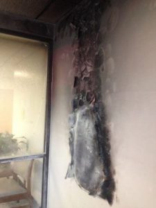 Heat from fire in newspaper recycling bin June 14, 2016 scorched wall and cracked glass window
