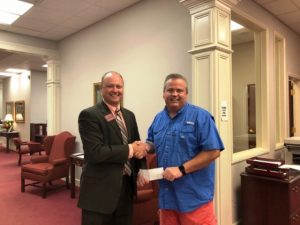 DCHS Project Graduation Committee President Blake Cantrell receives donation from Chad Colwell of Wilson Bank & Trust
