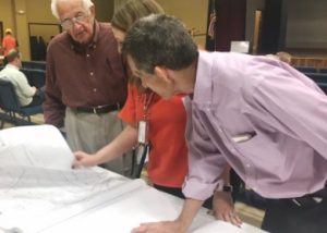 TDOT official shows Highway 56 plans to Erby France (left) and Phillip "Fluty" Cantrell (right)
