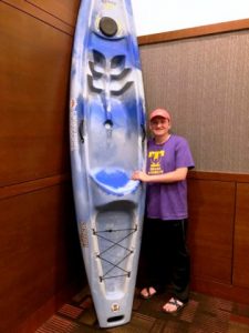 DCHS Class of 2018 President Tyree Cripps stands beside Jackson Kayak donated by Caney Fork Outdoors to benefit Project Graduation