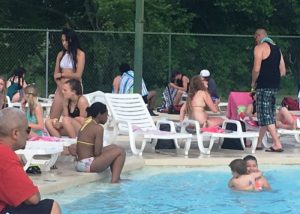 Kids and Grownups Enjoy City Swimming Pool