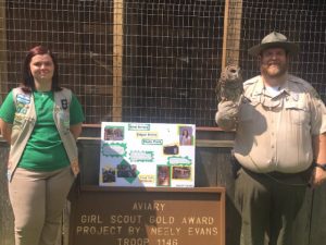 Girl Scout Neely Evans stands in front of new aviary she built as her Gold Award Project. Also pictured in Brad Halfacre, Park Ranger at Edgar Evins State Park holding "McKenzie", a barred Owl that will be housed in the aviary