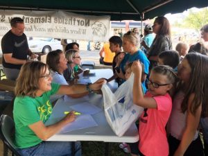 Northside Elementary Assistant Principal Beth Pafford and teachers passing out free school supplies during Education Celebration downtown