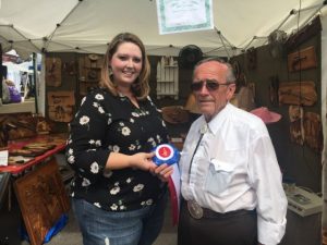 Jim Everett of Morrison received the Jamboree's "Best of Show" craft award Saturday for his three dimensional wood art. The award was presented by Dana Scott, Director of Crafts