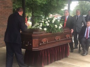 DeKalb Funeral Chapel staff bring the body of Jerry (Red) Foster back to the DCHS gym for his memorial service. The place where he coached girls basketball from 1993-2000 and where his high school jersey number was retired in a ceremony