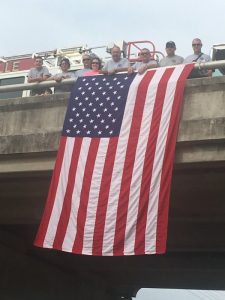 Members of the Smithville Volunteer Fire Department and families stood on the Veterans Memorial Bridge (College Street Bridge) overlooking West Broad Street last year to welcome motorcycle riders as they passed through enroute to Bell Buckle on a charity ride to raise funds for the Tennessee Fallen Firefighters Memorial