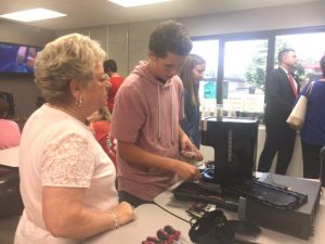 Brenda Cantrell of First Bank observes as DCHS student Richard Brown examines how to repair or make use of parts from a coffee pot for other purposes in the new Makerspace located in the DCHS Media Center/Library.