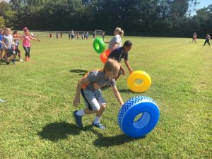 Fourth graders running obstacle course during fun run at Northside Elementary School