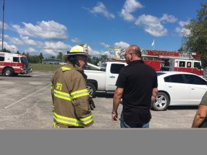 Smithville Fire Chief Charlie Parker speaking with Tracy Foutch, owner of Foutch Industries at scene of industry fire
