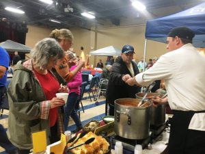 Jason Evans serving up chili from his booth “Just Good Chili” from The Inn at Evins Mill. during 2018 Habitat Chili Cook-Off