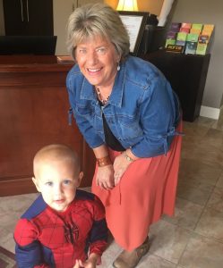 Pat Cantrell of DeKalb County Insurance Greets youngster during 2018 Trick or Treat Halloween Downtown
