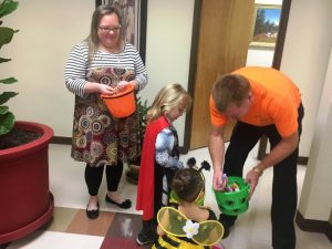 Trustee Sean Driver and Bridgette Rogers greet kids trick or treating during Halloween at the County Complex last year