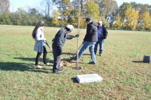 Members of Karen Jacobs’ family planting tree in her memory at Northside Elementary School daughter Caitlin Jacobs, mother Betty Blair, son Justin Nokes, and husband Shawn Jacobs