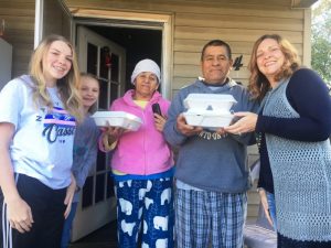 Third district County Commissioner Jenny Trapp (far right) and her daughters Hannah (far left) and Leah delivered Thanksgiving Day meals to local family last year