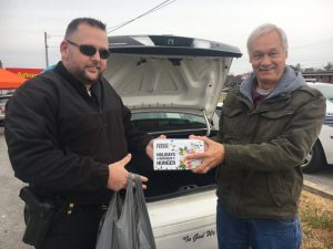 David Caldwell presented donation to Sergeant Travis Bryant of the Smithville Police Department in support of Cash Express’ 3rd annual “Fill the Police Car” event last year