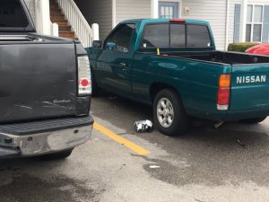 Patrick Lee's Buick Enclave struck these two trucks parked at Town Edge Village Apartments