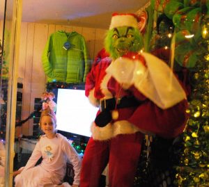 Christmas on the Square: CROWD FAVORITE: Deana Ruth Colwell as the Grinch and Lola Colwell as Cindy Lou Who as LIVE models in the store window of Cantrell’s the Home of Fluty