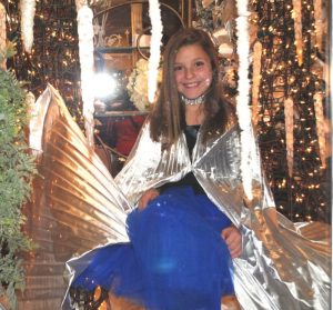2018 Christmas on the Square: Annabella Dakas is a LIVE Model in the store window of DeKalb County Florist portraying a character from Disney’s “Frozen”