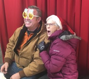 Christmas on the Square: Couple enjoys having funny photos made of themselves with special props and poses by Cosmo Creations photo booth