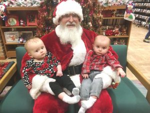 Christmas on the Square 2018: Santa posing for picture with Aislinn and Kenneth Dunn at Justin Potter Library