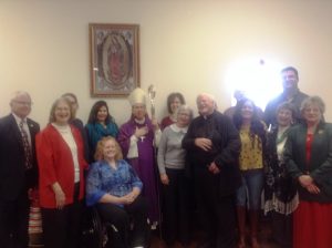 Bishop Mark Spalding visits with parishioners at St. Gregory's Catholic Church