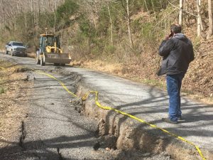 Road Supervisor Danny Hale surveys the scene of the damage to Davis Hollow Road Monday from the recent rains