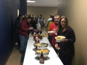 DCHS baseball fans line up for delicious chili and other treats during Monday night's annual fundraiser for the program