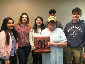 NHC resident Beth Pittman receives an ipad stand with the initial “B” on it made by DCHS students Elvia Rivera, Carrie Mooneyham, Elizabeth Orellana, Justin Gohs, and Conner Rice through the STEM Technology and CTE programs in partnership with NHC Health Care Center of Smithville