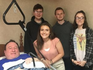 NHC resident Michael Young receives a hand splint made by DCHS students Bailey Hibdon (standing behind her) Ben Felton, Jackub Osment and Channon Stone through the STEM Technology and CTE programs in partnership with NHC Health Care Center of Smithville