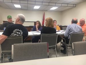 County budget committee: left to right Jeff Barnes, Jerry Adcock (back to camera) Anita Puckett, Sabrina Farler (back to camera), and Chairman Dennis Slager shown speaking to County Mayor Tim Stribling (back to camera)