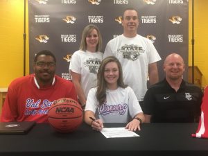 DCHS Senior Lady Tiger Lydia Brown signed a letter of intent to play basketball for the Vol State Community College Lady Pioneers. Pictured: seated-Vol State Women’s Head Coach Otis Key, Lydia Brown, and Lady Tiger Coach Danny Fish. Standing. Lydia’s parents Amanda and Stephen Brown