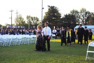 Junior Ushers Emme Colwell and Isaac Cross lead the DCHS Class of 2019 onto the football field for Graduation Friday Night