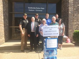 (PICTURED: #1 Smithville Chapter #374 leaders of the Order of the Eastern Star showed their appreciation to the Smithville Police Department Wednesday by donating three cases of bottled water. Pictured: Police Chief Mark Collins, Eastern Star Chaplain Dr. Robert R. Atnip, Police Sergeant Lance Dillard, Eastern Star Worthy Matron Pat Wilt, Police Captain Steven Leffew, Eastern Star Worthy Patron Dr. Jerry Paul Vanatta, Police Officer Brandon Donnell, and Eastern Star Organist Gay Vanatta)