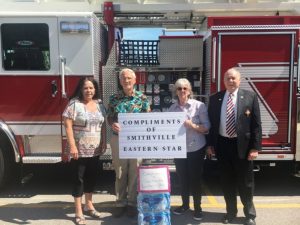 (PICTURED: #2 Smithville Chapter #374 leaders of the Order of the Eastern Star showed their appreciation to the Smithville Volunteer Fire Department Wednesday by donating three cases of bottled water. Pictured: Eastern Star Organist Gay Vanatta, Worthy Patron Dr. Jerry Paul Vanatta, Eastern Star Worthy Matron Pat Wilt, and Eastern Star Chaplain Dr. Robert R. Atnip)