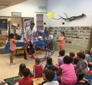 Professor Graybeard” (John Wicks) one of Mr. Bond’s Science Guys demonstrated for kids the forces of gravity on objects during Opening Day of 2019 Summer Reading Program at Justin Potter Library