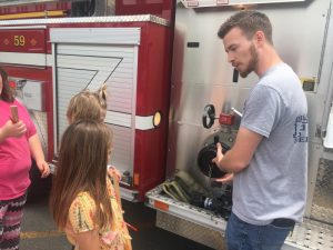 Students attending summer school at Northside Elementary School Tuesday were treated to a visit from members of the DeKalb County Volunteer Fire Department. Matt Adcock, Station Commander of the Belk Station shows the kids how the fire truck operates.
