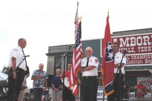 Honor Guards Captain Jeff Wright and Lieutenants Kevin Adcock and John Poss of the Smithville Fire Department Post Colors during the Opening Ceremony for the Fiddlers Jamboree Friday evening