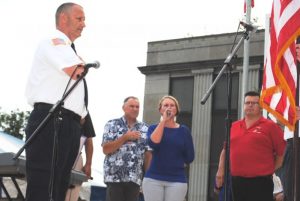 Emily Phillips sings the National Anthem during Fiddlers Jamboree Opening Ceremony Friday evening