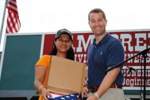 State Representative Clark Boyd gave a United States flag to Maylin Phillips of the Phillipines.