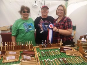 Fiddler’s Jamboree Director of Crafts Dana Scott presents “Best of Show” Award to Dale and Claire Penn of Penn’s Pens in Hendersonville.