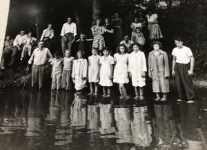 Photo shows gathering at the last baptismal in Indian Creek on July 28, 1946 before the church moved to its current location.